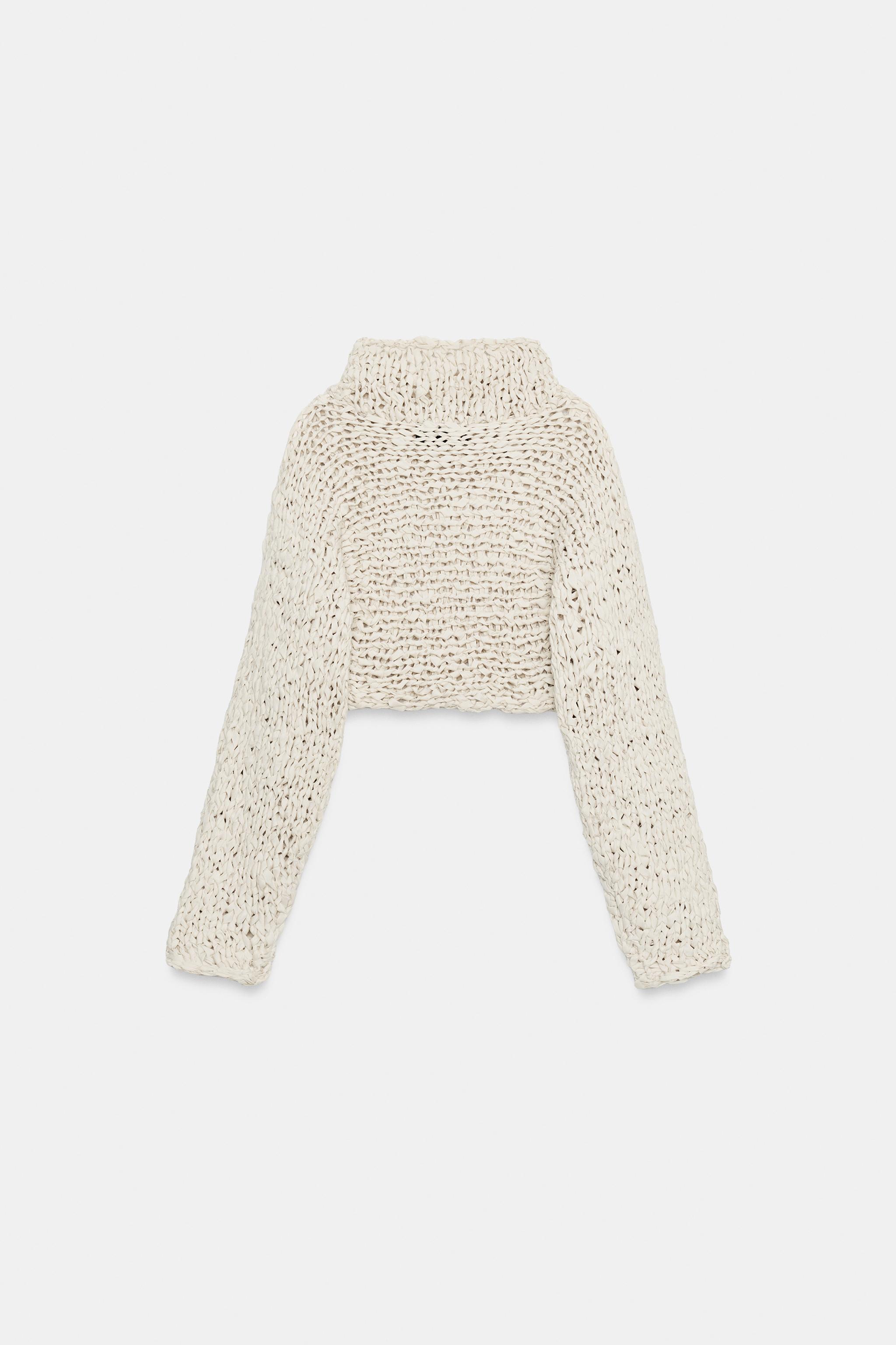 PULL COURT EN MAILLE À BANDE ENTRELAÇÉE